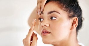woman putting in contact lenses